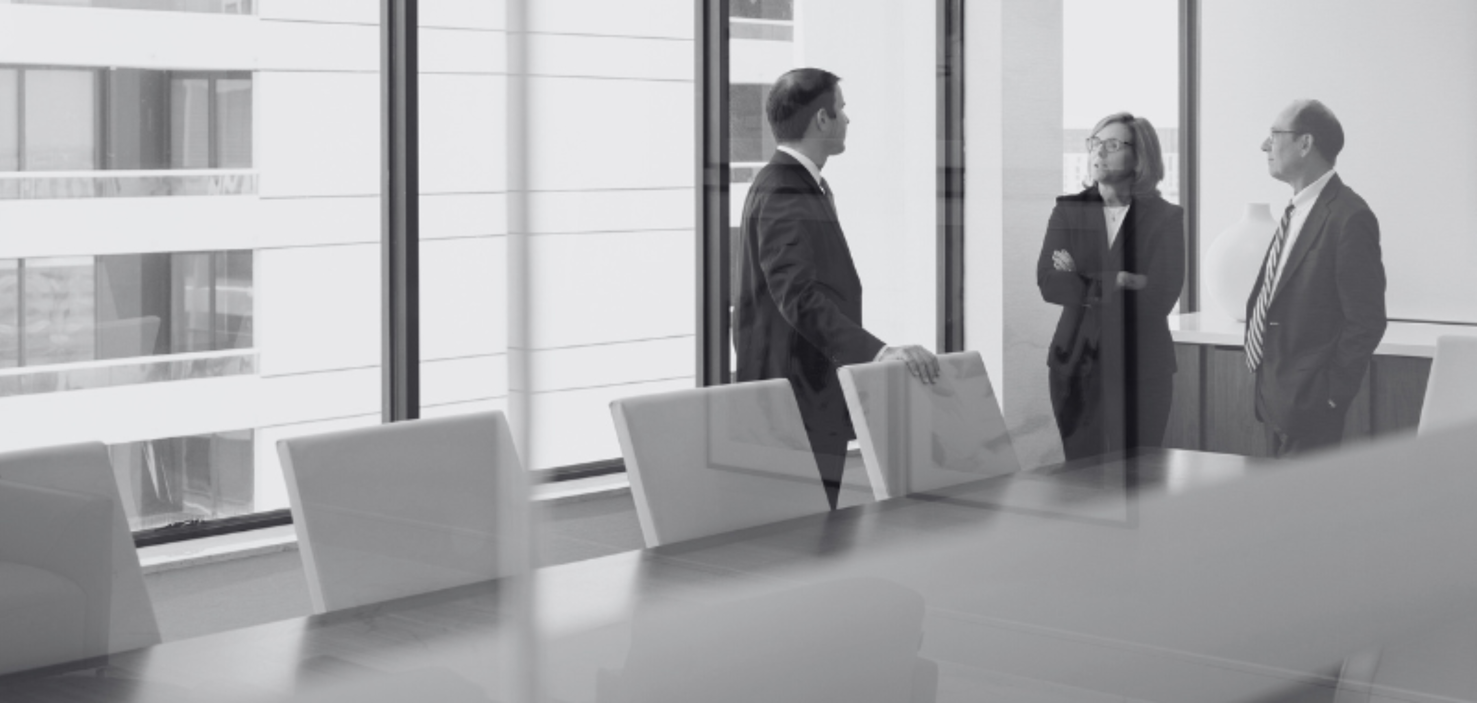 Bill Smith Joanne O Connor and Scott Hawkins Stand in Jones Fosters Executive Conference Room